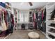 Large walk-in closet with custom shelving, natural light, and carpeted floors at 3010 La Mesa Dr, Henderson, NV 89014