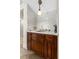 Elegant wet bar with dark wood cabinets, striking patterned backsplash, and decorative lighting fixture at 3010 La Mesa Dr, Henderson, NV 89014