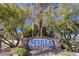 Stone sign surrounded by lush trees and shrubbery welcomes you to the Sevilla community at 3135 S Mojave Rd # 241, Las Vegas, NV 89121