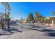 Wide shot showcasing the gated community entrance, mature trees, and resident parking at 3135 S Mojave Rd # 241, Las Vegas, NV 89121