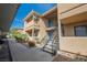 Apartment building exterior featuring tan stucco and stairs leading to the upper units at 3135 S Mojave Rd # 241, Las Vegas, NV 89121