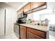 Updated kitchen featuring light countertops, white tile floors, and stainless steel appliances at 3135 S Mojave Rd # 241, Las Vegas, NV 89121