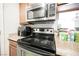Modern kitchen featuring stainless steel appliances, wood cabinets, and stone countertops at 3135 S Mojave Rd # 241, Las Vegas, NV 89121