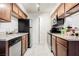 Well-lit kitchen features stainless steel appliances, tile floors, and wood cabinets at 3135 S Mojave Rd # 241, Las Vegas, NV 89121