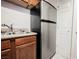 Close up view of kitchen area including stainless steel refrigerator and sink at 3135 S Mojave Rd # 241, Las Vegas, NV 89121
