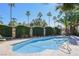 Community pool with clear blue water, surrounded by lush greenery at 3135 S Mojave Rd # 241, Las Vegas, NV 89121