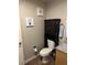 Well-organized bathroom featuring a toilet, cabinet and vanity with a granite countertop, tiled floors and wall accents at 353 E Bonneville Ave # 631, Las Vegas, NV 89101