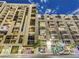 Exterior of a modern apartment building with balconies, street-level shops and restaurants on a clear day at 353 E Bonneville Ave # 631, Las Vegas, NV 89101