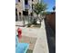 Exterior common area walkway for residents with sitting benches, a fire hydrant, and well-maintained landscaping at 353 E Bonneville Ave # 631, Las Vegas, NV 89101