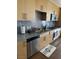 Well-equipped kitchen with stainless steel appliances, granite countertops, and light wood cabinetry with tiled floors at 353 E Bonneville Ave # 631, Las Vegas, NV 89101