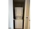 A modern, stacked, white washer and dryer unit inside the laundry closet with easy access and thermostat at 353 E Bonneville Ave # 631, Las Vegas, NV 89101