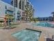 Community pool and hot tub with lounge seating and palm trees at 353 E Bonneville Ave # 631, Las Vegas, NV 89101