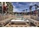 Community pool with lounge seating and palm trees at 353 E Bonneville Ave # 631, Las Vegas, NV 89101