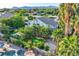 Aerial shot of home with pool, spa, landscaping, mature trees and covered patio at 3560 Five Pennies Ln, Las Vegas, NV 89120