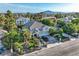 Stunning aerial view of a beautiful home featuring lush landscaping and a gated entrance, with mountain views in the background at 3560 Five Pennies Ln, Las Vegas, NV 89120