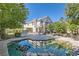 Backyard showcasing pool, landscaped yard, patio area, and spiral staircase at 3560 Five Pennies Ln, Las Vegas, NV 89120