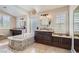Bright primary bathroom features a soaking tub, granite countertops, dual sinks, and shuttered windows at 3560 Five Pennies Ln, Las Vegas, NV 89120