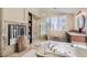 Bright bathroom boasts soaking tub, glass enclosed shower, and modern finishes at 3560 Five Pennies Ln, Las Vegas, NV 89120