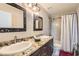 Bathroom featuring granite counters, dual sinks, shower, toilet, and decorative mirrors at 3560 Five Pennies Ln, Las Vegas, NV 89120