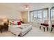 Cozy bedroom featuring a large window, comfortable bed, and built-in storage at 3560 Five Pennies Ln, Las Vegas, NV 89120