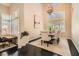Bright dining room with large windows, plantation shutters, and an elegant chandelier, creating a sophisticated atmosphere at 3560 Five Pennies Ln, Las Vegas, NV 89120