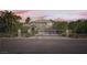 Elegant home with a gated entrance and lush landscaping for privacy and curb appeal at 3560 Five Pennies Ln, Las Vegas, NV 89120