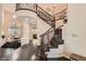 Grand foyer featuring a curved staircase, soaring ceilings, and elegant chandelier, creating a luxurious entrance at 3560 Five Pennies Ln, Las Vegas, NV 89120
