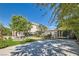 Charming home showcasing a well-manicured lawn, mature trees, and a gated driveway providing privacy and curb appeal at 3560 Five Pennies Ln, Las Vegas, NV 89120