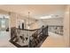 Bright hallway with skylight and iron railing with view of the living room below at 3560 Five Pennies Ln, Las Vegas, NV 89120