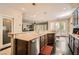 Stylish kitchen features dark cabinets, stone countertops, stainless appliances and wood floors at 3560 Five Pennies Ln, Las Vegas, NV 89120