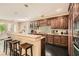 Well-appointed kitchen featuring dark wood cabinets, a breakfast bar, and modern appliances, ideal for cooking and entertaining at 3560 Five Pennies Ln, Las Vegas, NV 89120