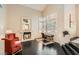 Comfortable living room with a fireplace, large windows, and dark wood floors, offering a cozy and inviting space at 3560 Five Pennies Ln, Las Vegas, NV 89120