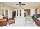 Spacious living room featuring neutral carpeting, large mirror, comfortable seating, and ceiling fan at 3560 Five Pennies Ln, Las Vegas, NV 89120