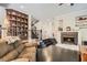 Inviting living room with fireplace, built-in shelving, and dark wood flooring at 3560 Five Pennies Ln, Las Vegas, NV 89120