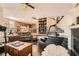 Open concept living room with fireplace, built-in shelving, and dark wood flooring at 3560 Five Pennies Ln, Las Vegas, NV 89120