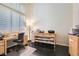 Bright home office with large windows, dark flooring, and custom cabinets at 3560 Five Pennies Ln, Las Vegas, NV 89120