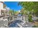 Outdoor kitchen featuring stone countertops, grill, sink, and space for entertaining at 3560 Five Pennies Ln, Las Vegas, NV 89120