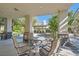 Outdoor patio seating area with a stone table and wrought iron chairs for relaxing and entertaining at 3560 Five Pennies Ln, Las Vegas, NV 89120