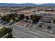 A high-angle aerial shot showcasing a property with mature trees, desert landscaping, and surrounding neighborhood at 3580 Unicorn Ave, Pahrump, NV 89048
