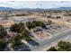 Expansive aerial view of a residential property with mature trees and desert landscaping in a suburban neighborhood at 3580 Unicorn Ave, Pahrump, NV 89048