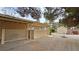 View of backyard with covered patio, storage shed, and gravel landscaping for easy maintenance at 3580 Unicorn Ave, Pahrump, NV 89048