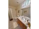 Bathroom featuring a shower-tub combo, framed mirror and wooden vanity at 3580 Unicorn Ave, Pahrump, NV 89048