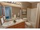 Bathroom featuring a dual sink vanity, framed mirror, and a shower-tub combo at 3580 Unicorn Ave, Pahrump, NV 89048