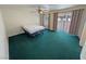 Expansive bedroom featuring green carpeting, a ceiling fan, and sliding glass doors to the backyard at 3580 Unicorn Ave, Pahrump, NV 89048