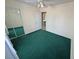 A cozy bedroom with green carpet, white walls, and a mirrored closet at 3580 Unicorn Ave, Pahrump, NV 89048