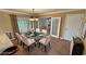 This staged dining room features a glass table, comfortable seating and great natural light at 3580 Unicorn Ave, Pahrump, NV 89048