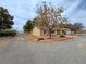 Wide angle exterior featuring desert landscaping, mature trees, and side views of the home at 3580 Unicorn Ave, Pahrump, NV 89048