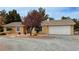 Inviting front exterior of home with manicured landscaping, charming walkway and attached garage at 3580 Unicorn Ave, Pahrump, NV 89048