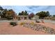 Expansive front yard featuring desert landscaping, mature trees and attractive curb appeal at 3580 Unicorn Ave, Pahrump, NV 89048