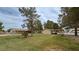 Spacious front yard with mature trees and well-maintained grass, enhancing the property's curb appeal at 3580 Unicorn Ave, Pahrump, NV 89048